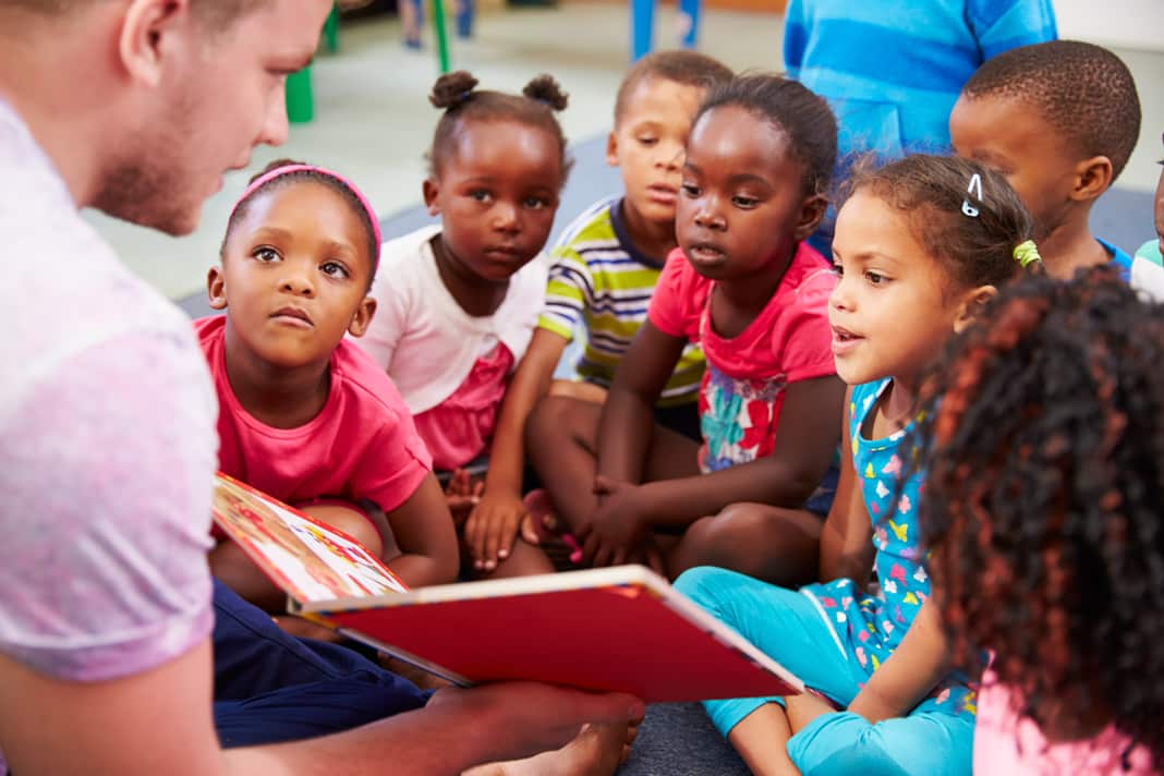 Volunteering Student Reading To Children